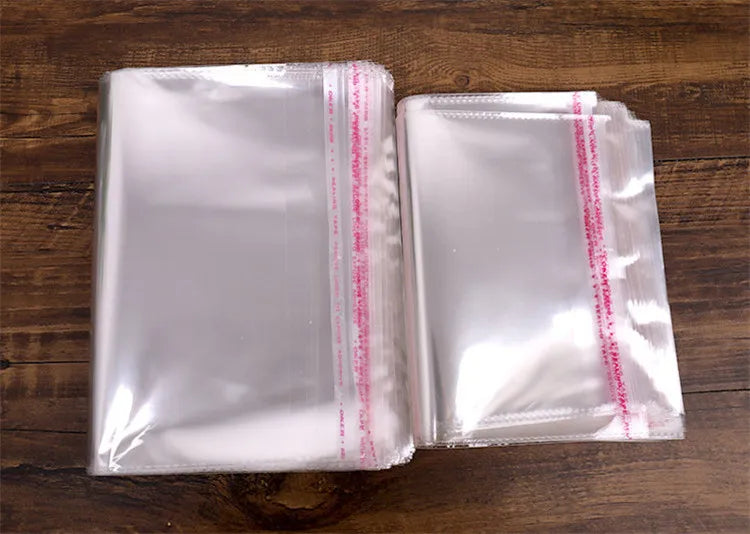 100PCS Sacos Adesivos Transparentes OPP de 20~55cm de Largura para Embalagem de Roupas, Calçados, Camisetas, Meias, Roupas Íntimas, Brinquedos, Livros e Presentes